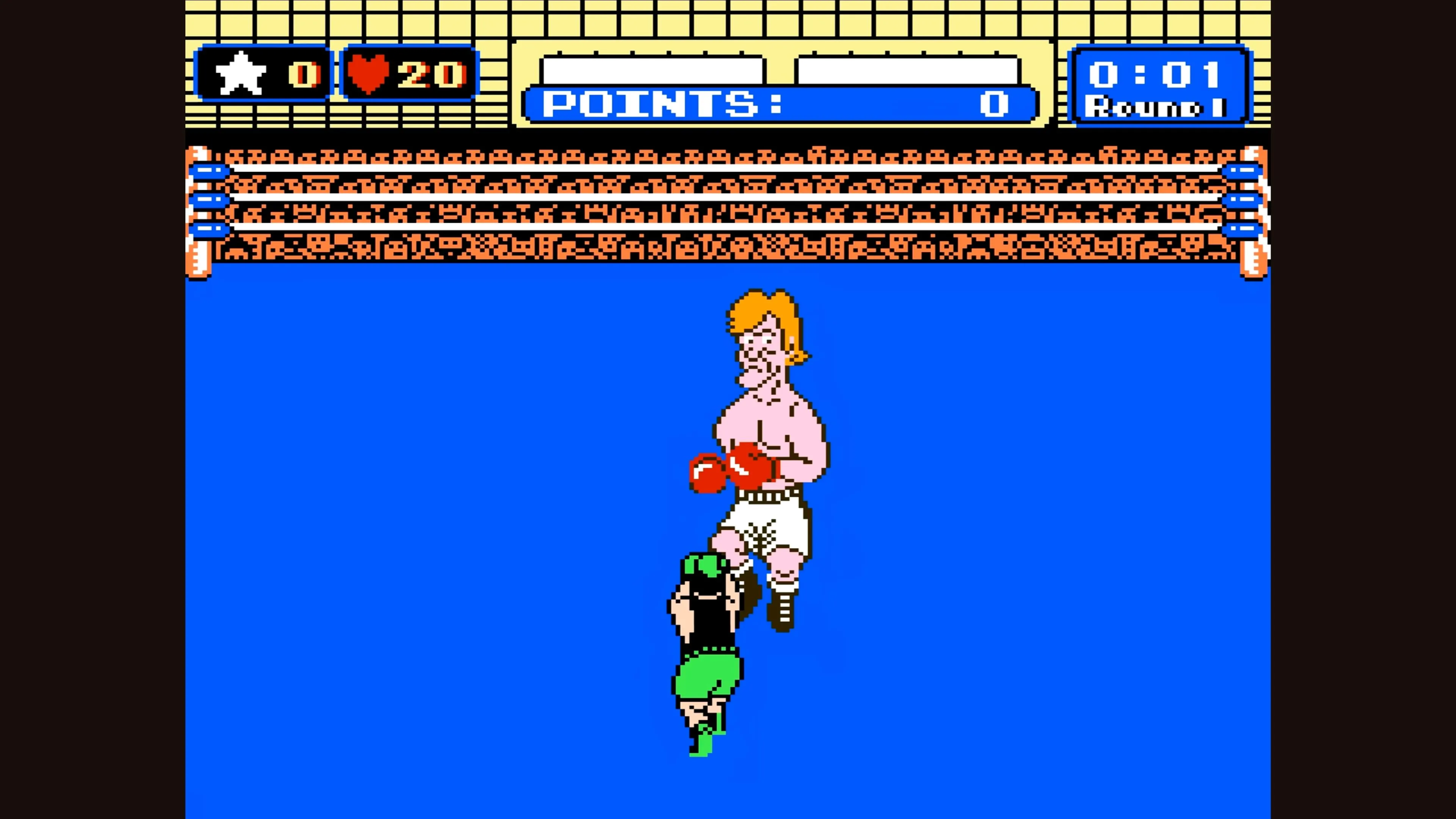 Little Mac chiến đấu với một đối thủ tóc vàng trên sàn đấu boxing trong Punch-Out!!.