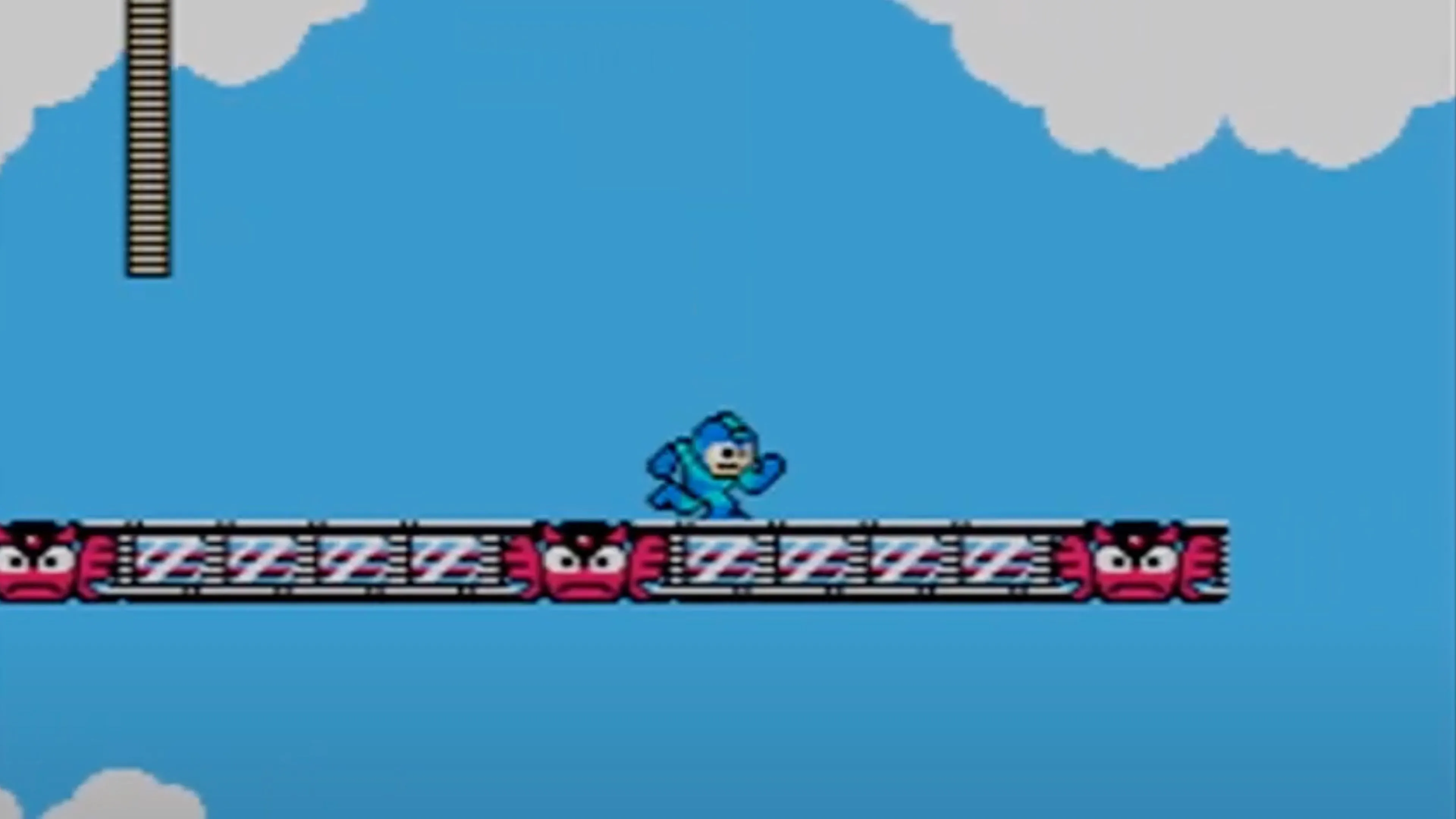 Mega Man đang nhảy và bắn robot kẻ thù trong một cảnh chơi game Mega Man 2.