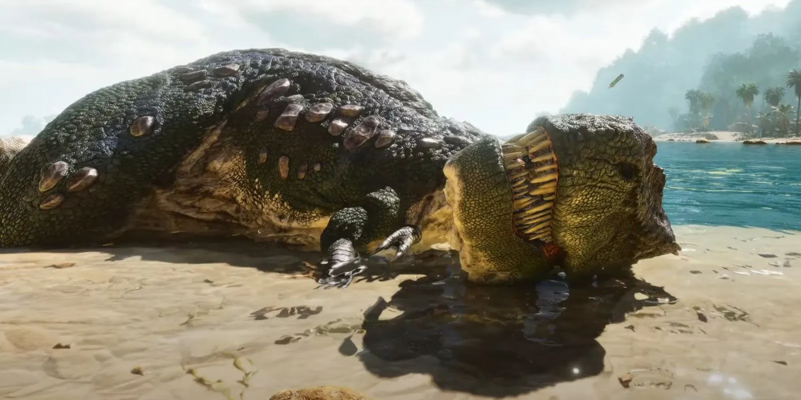 Một con khủng long bạo chúa T-Rex cấp thấp nằm thư giãn trên bãi biển trong Ark: Survival Ascended