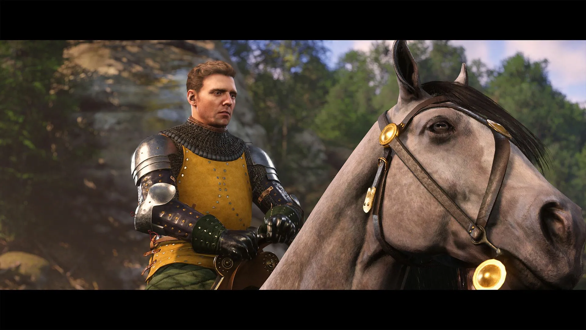 Một nhóm người đang di chuyển qua cánh đồng trong Kingdom Come Deliverance II