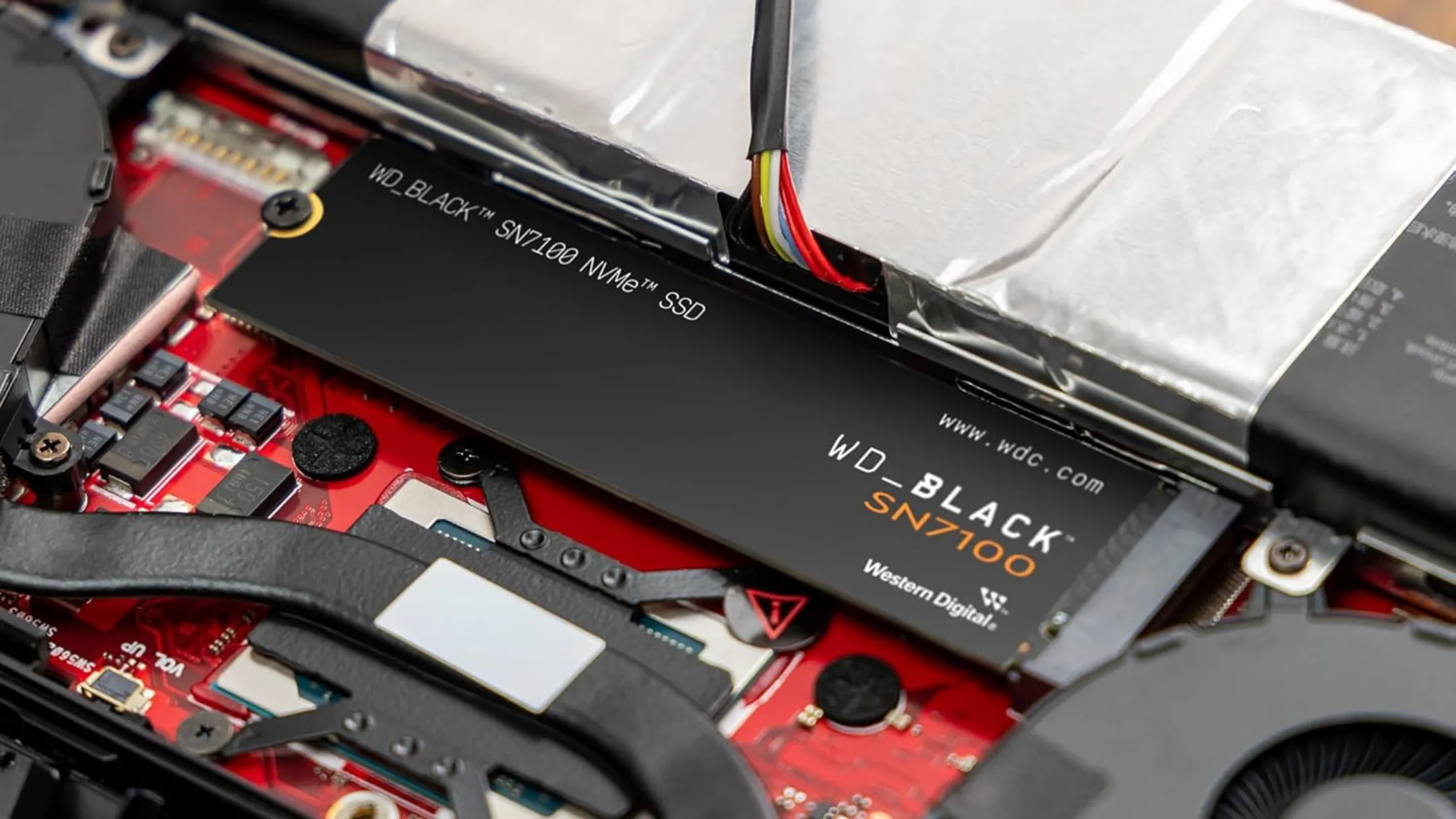 Ổ cứng SSD nội bộ chơi game WD_BLACK 4TB SN7100 NVMe được gắn trong một thiết bị, đại diện cho công nghệ tăng tốc độ tải game trên console hiện tại.